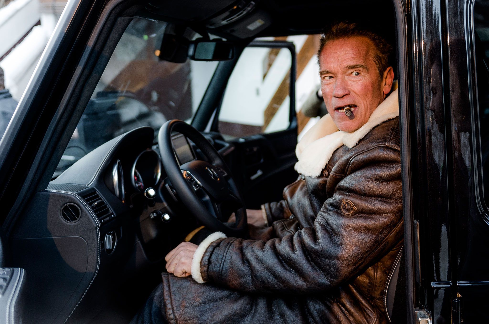 Arnold Schwarzenegger at the driver's seat of his electric G-wagon