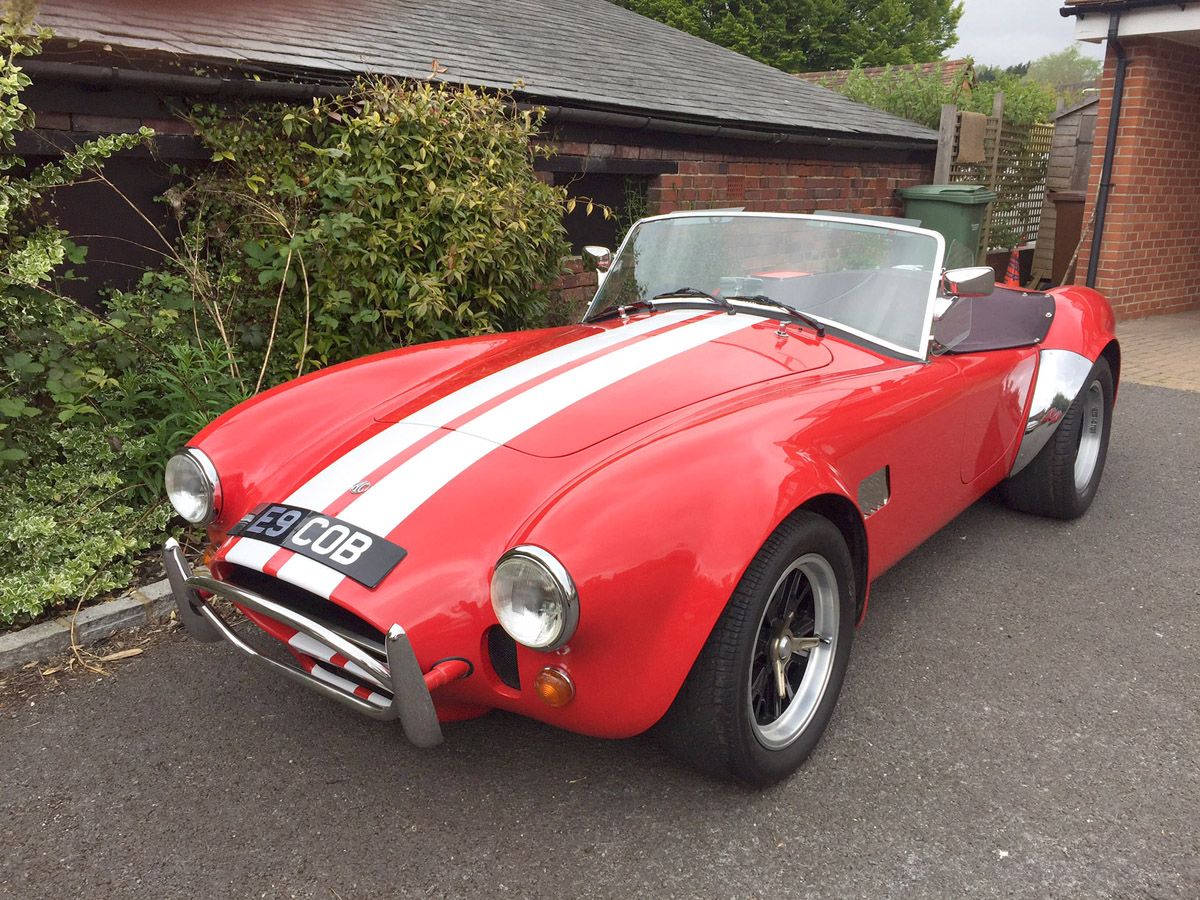 Simon Cowell's red AC Cobra parked