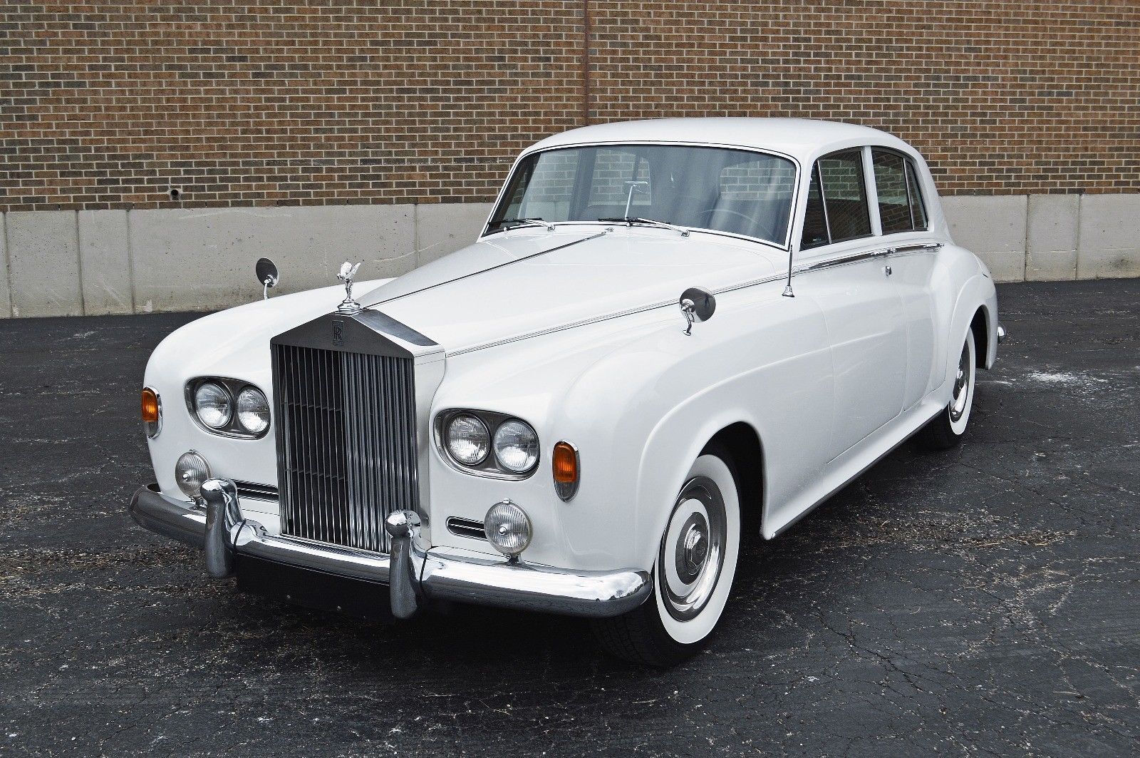 Simon Cowell's white Rolls-Royce Silver Cloud III parked next to wall