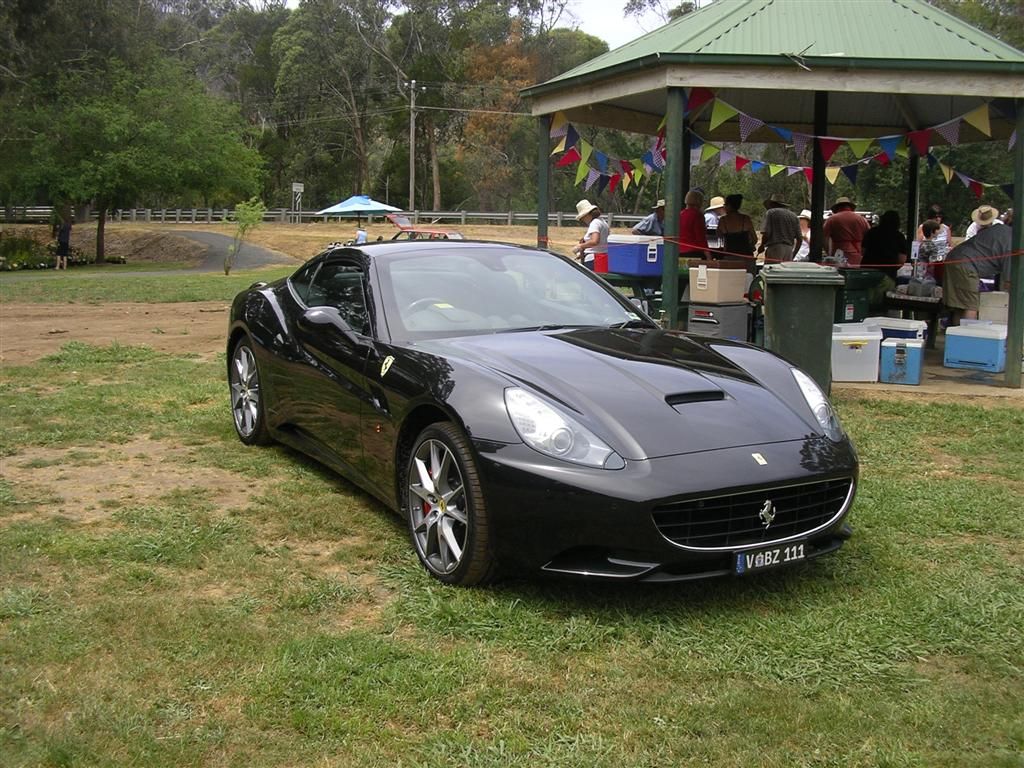 Simon Cowell's Black Ferrari 566 California parked on the grass