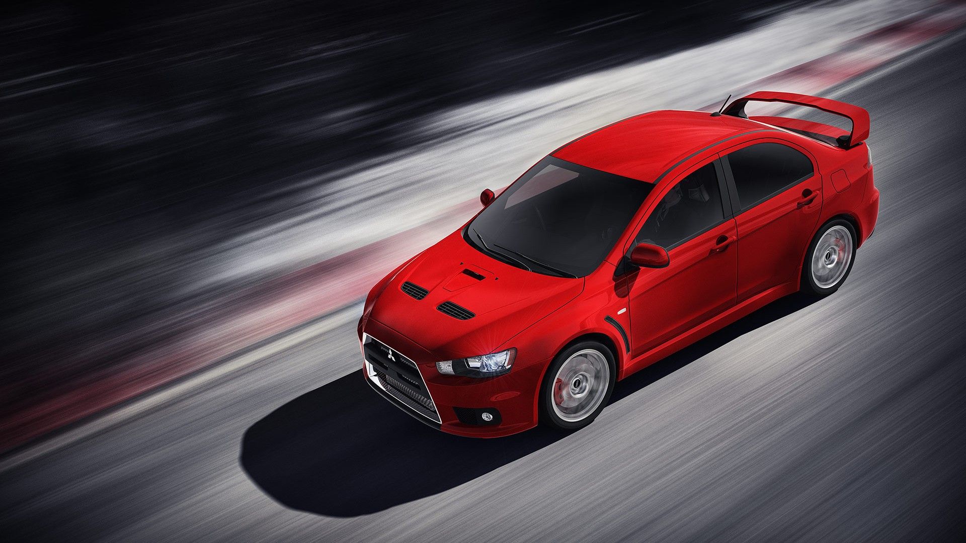 Lancer Evolution X merah melaju di jalan