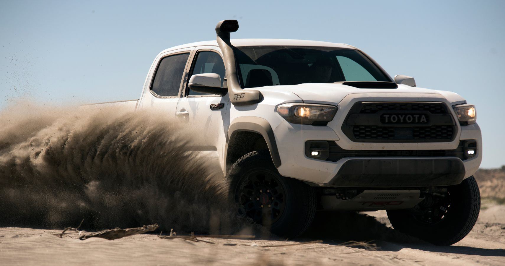 The 2019 Toyota Tacoma TRD Pro drives over sand dunes