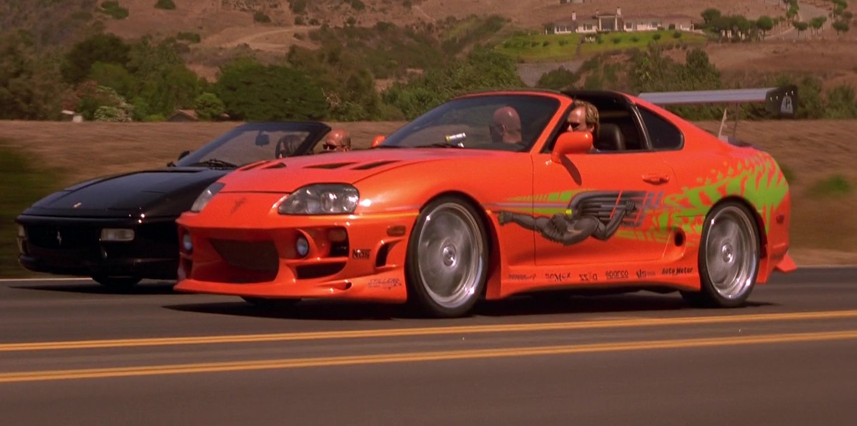 Toyota Supra racing against a Ferrari on a highway in The Fast And The Furious 