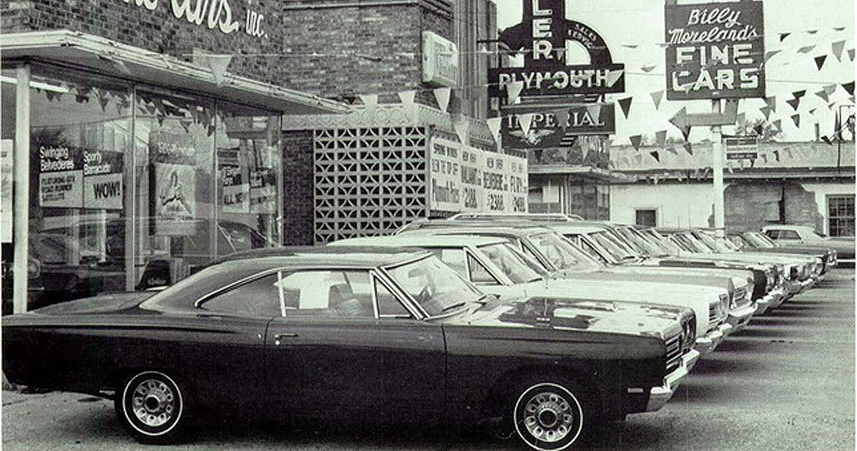 A long line of 1968 Plymouth Roadrunners among other cars
