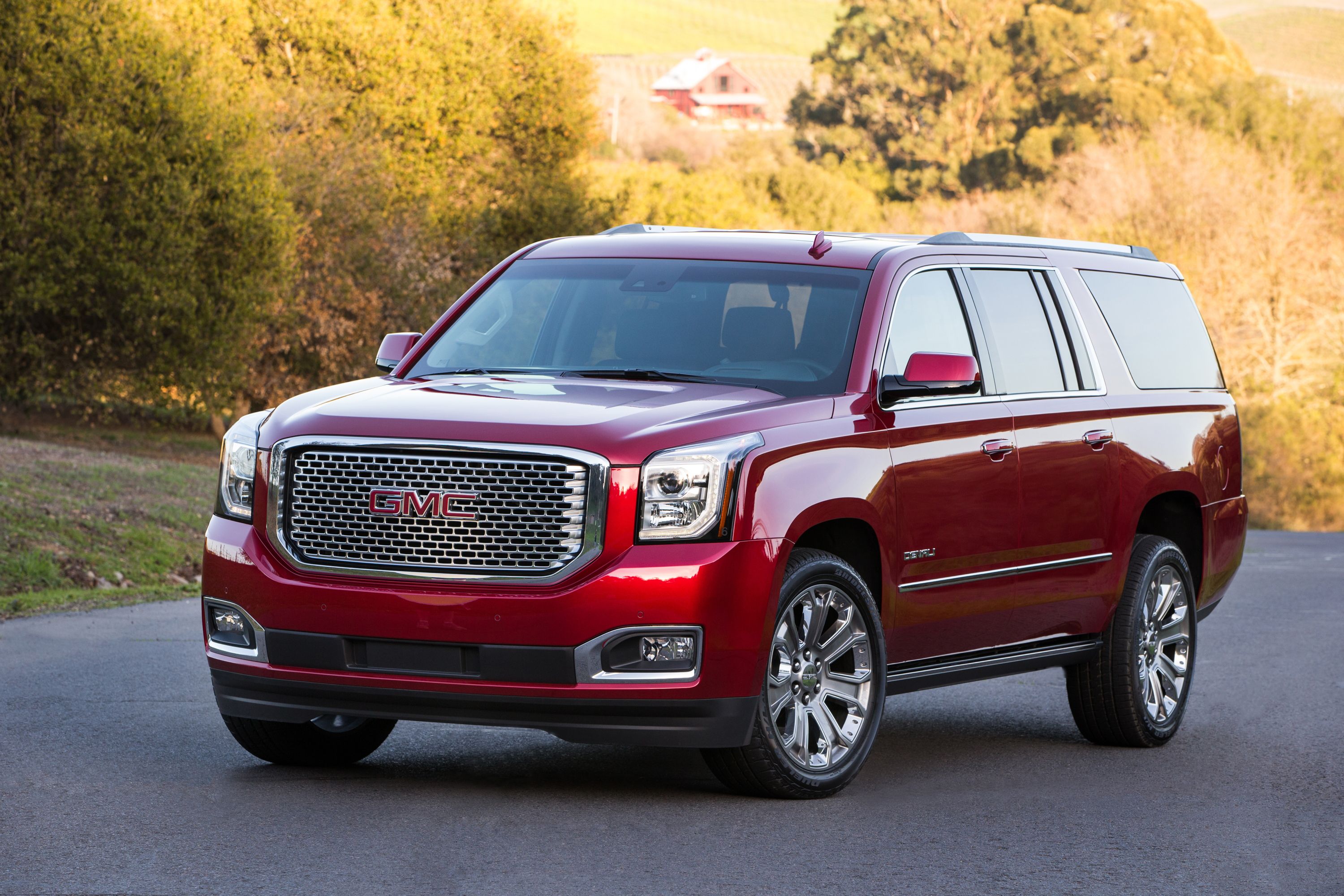 Cherry Red 2016 GMC Yukon outdoors in the forest