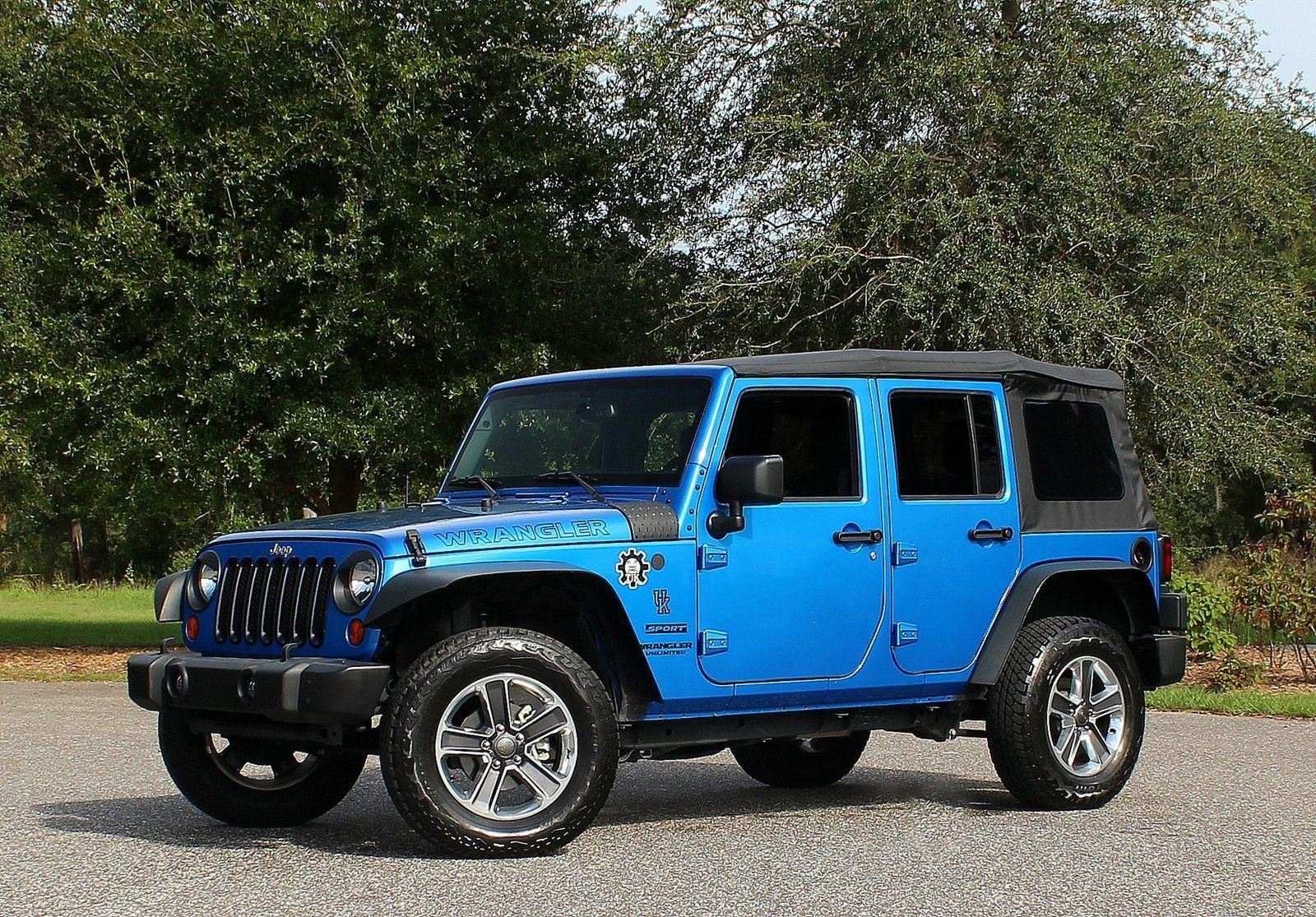 Bright Blue 2016 Jeep Wrangler Unlimited outdoors in forest
