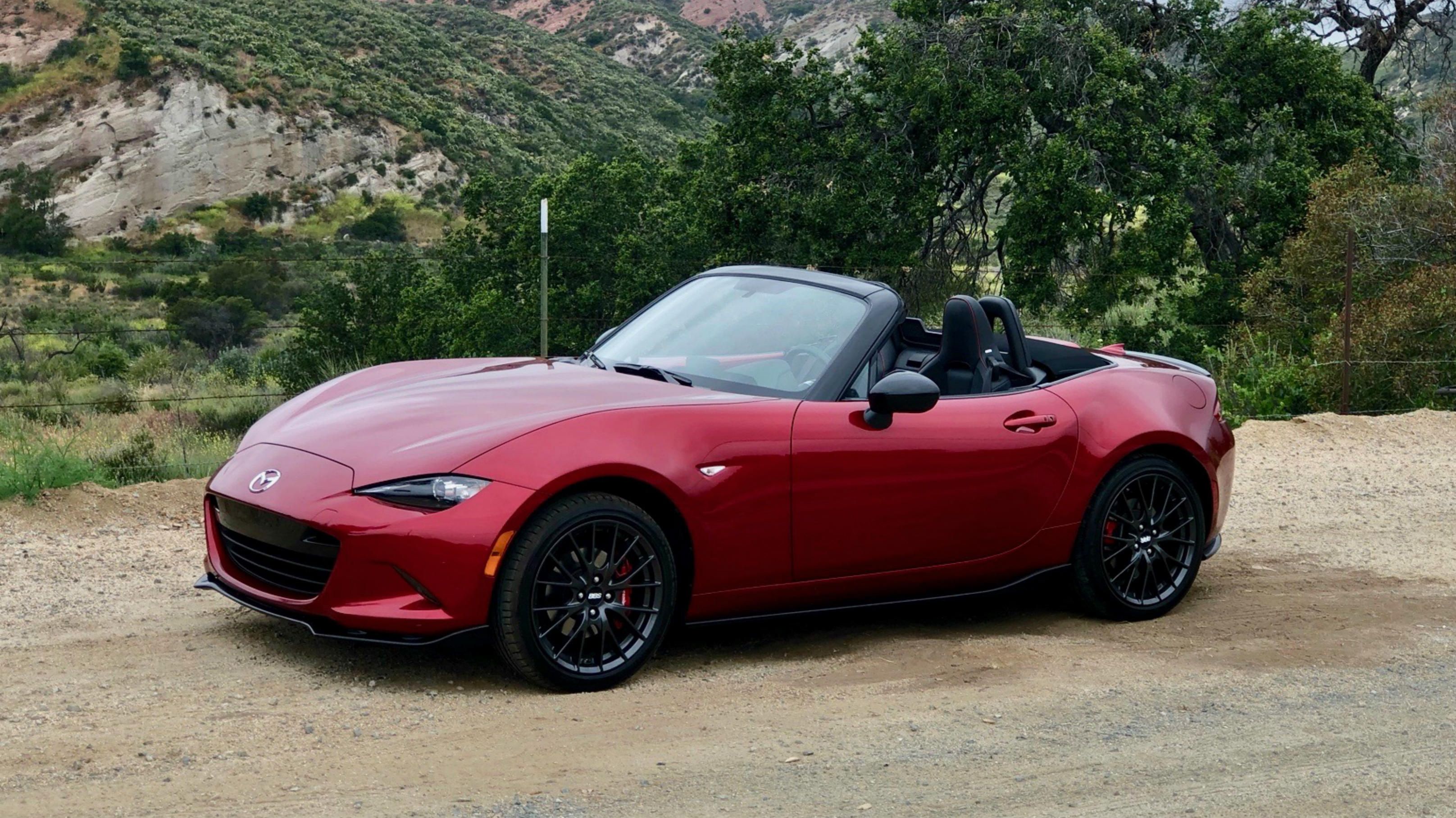 Cherry red convertible 2019 Mazda MX-5 off road