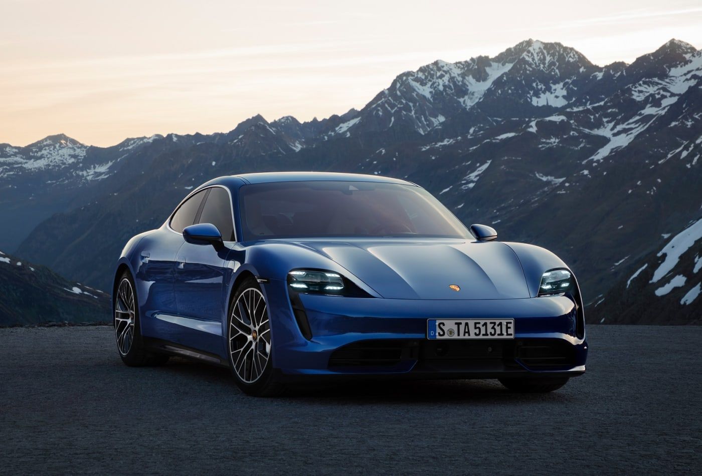 Blue luxury electric vehicle with mountains