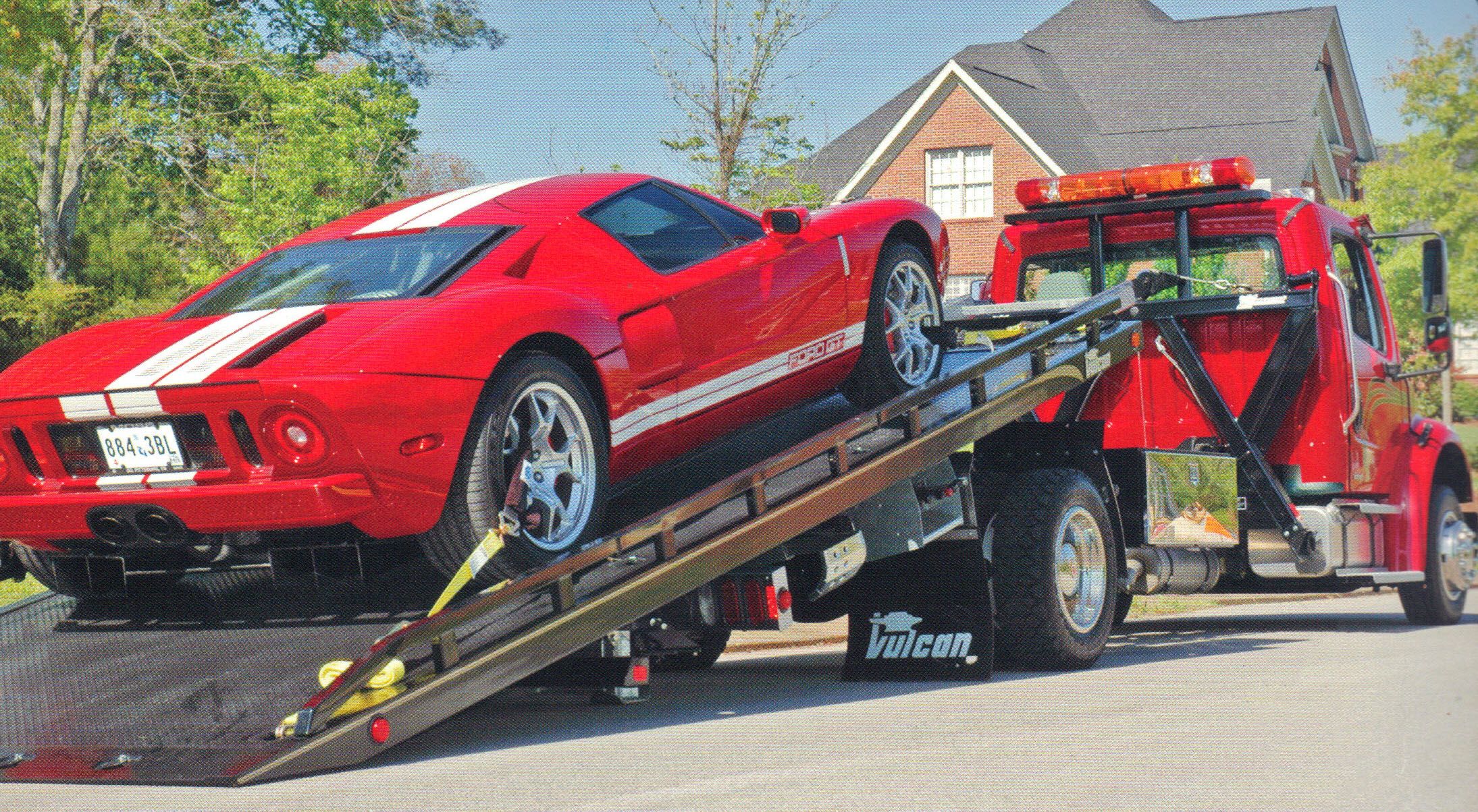 A Red Ford GT is towed