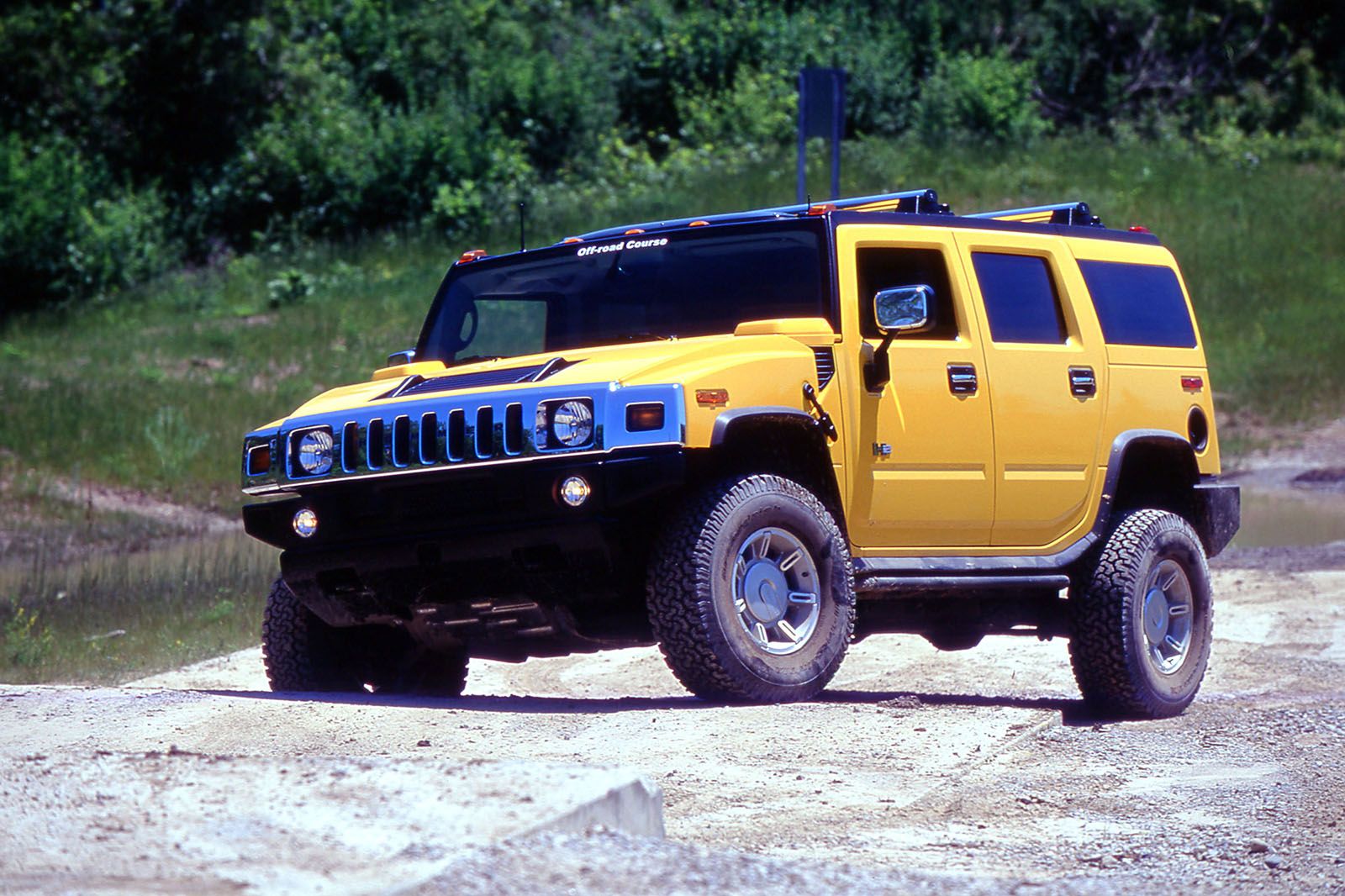 Bright Yellow Hummer H2 off-road outdoors forest