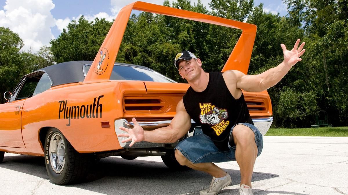John Cena in front ofplymouth road runner superbird