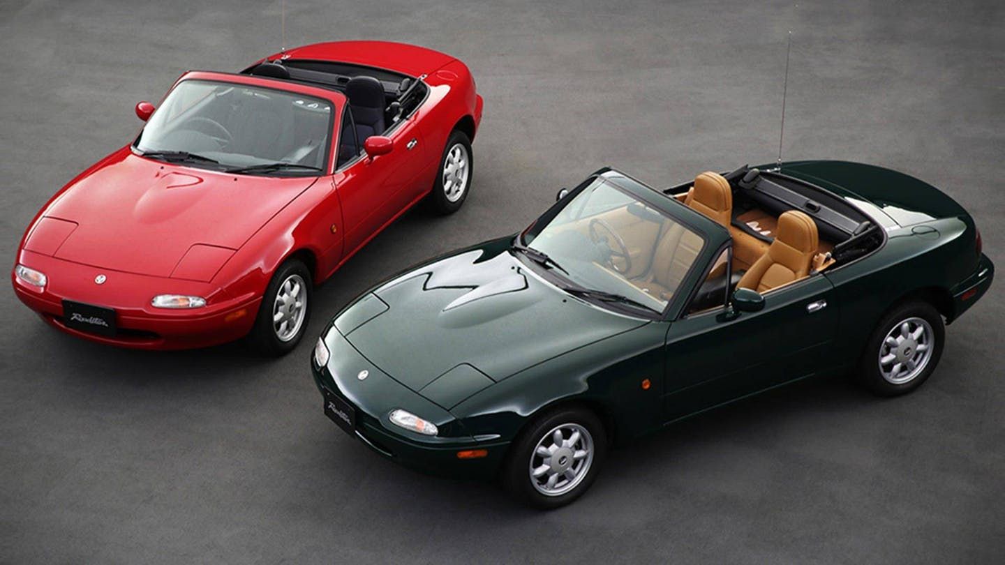 green and red mazda miatas parked