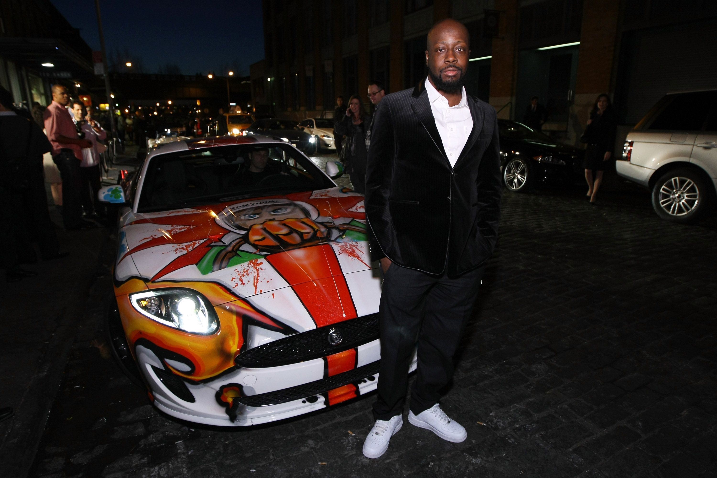 Wyclef Jean In Front Of White Jaguar XKR