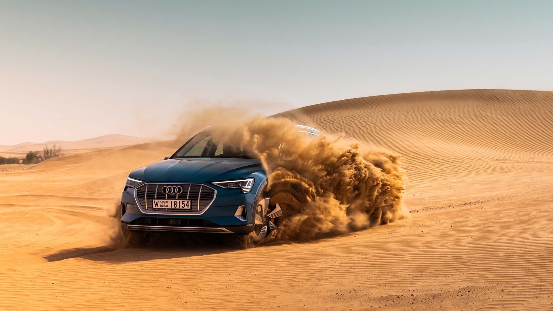2020 blue Audi E-Tron in the sand