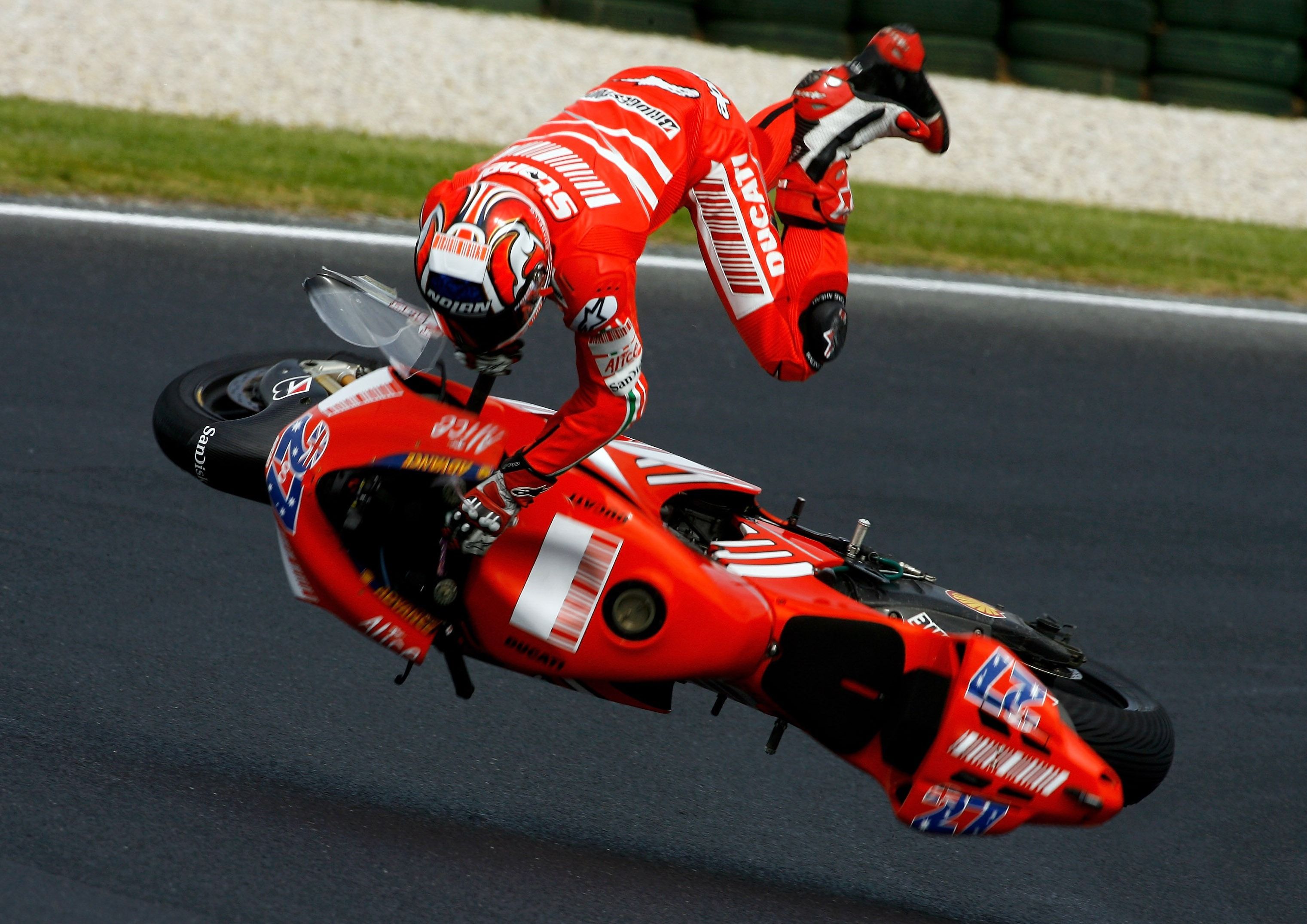 Rider falls from a red Ducati racing motorbike
