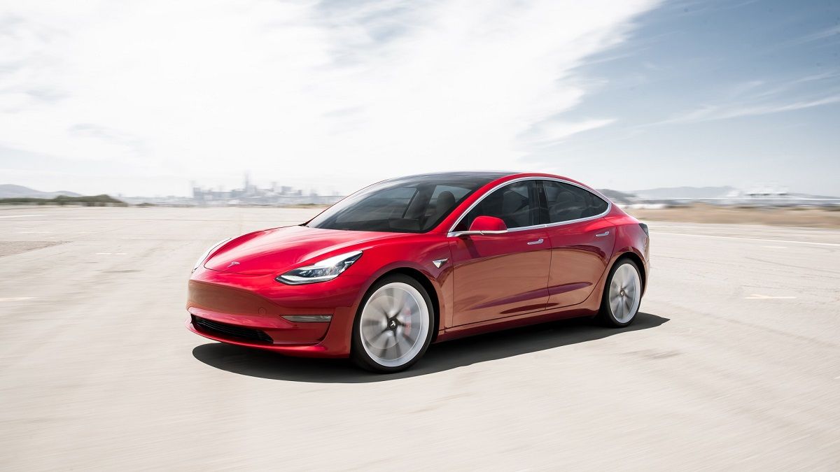 Red 2019 Tesla Model 3 parked in the desert