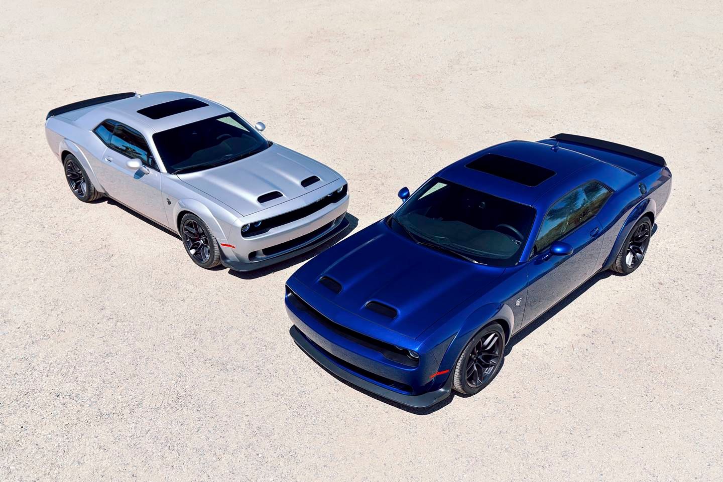 a silver and a blue dodge challenger hellcats side by side