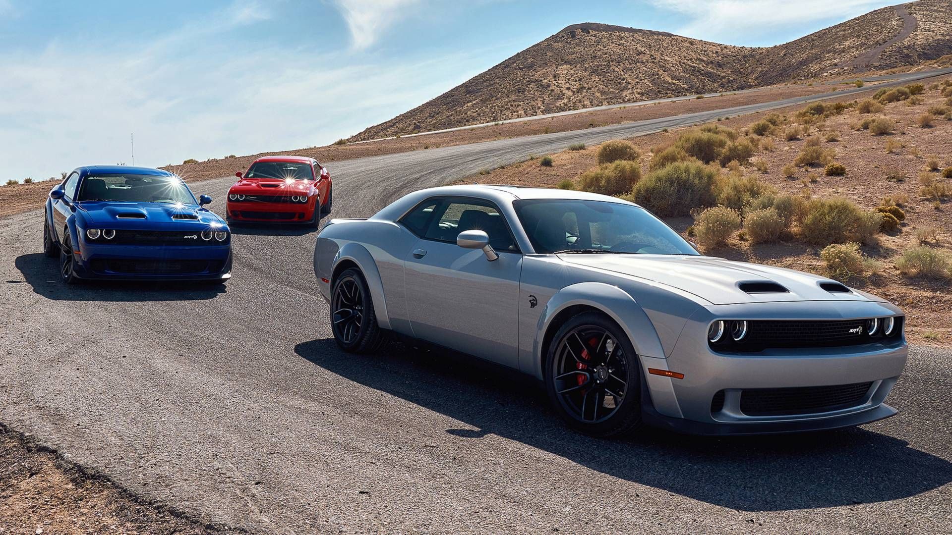 silver, red and blue hellcats on the road