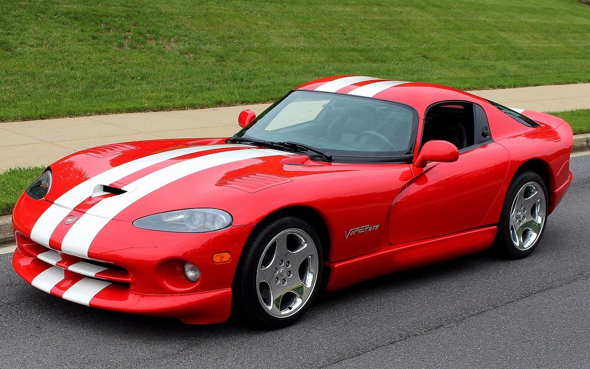 Red 2002 Dodge Viper with white stripes parked front 3/4 view