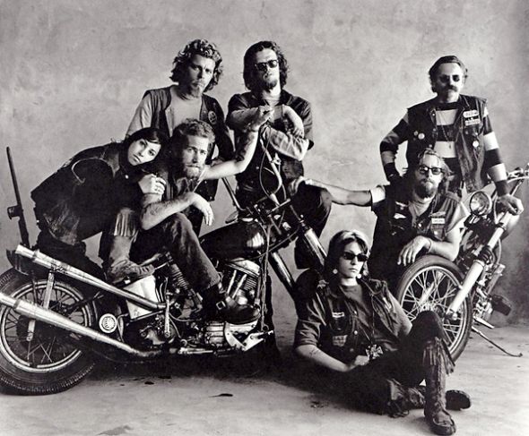 A group of Hell's Angels poses together almost playfully, looking more like a music club than an MC club.