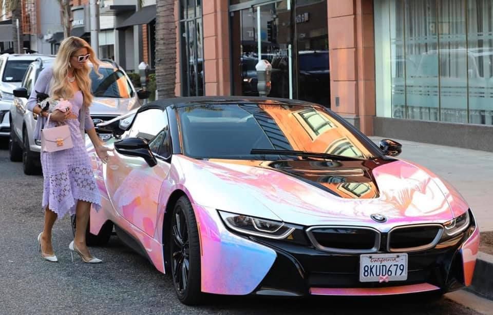 Paris Hilton approaching the passenger door of her holographic BMW i8