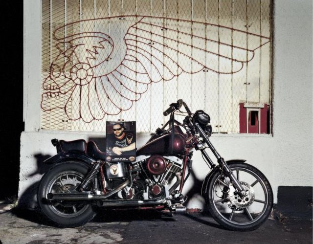 A fallen Angel is memorialized with a mural, his photo, and his bike.