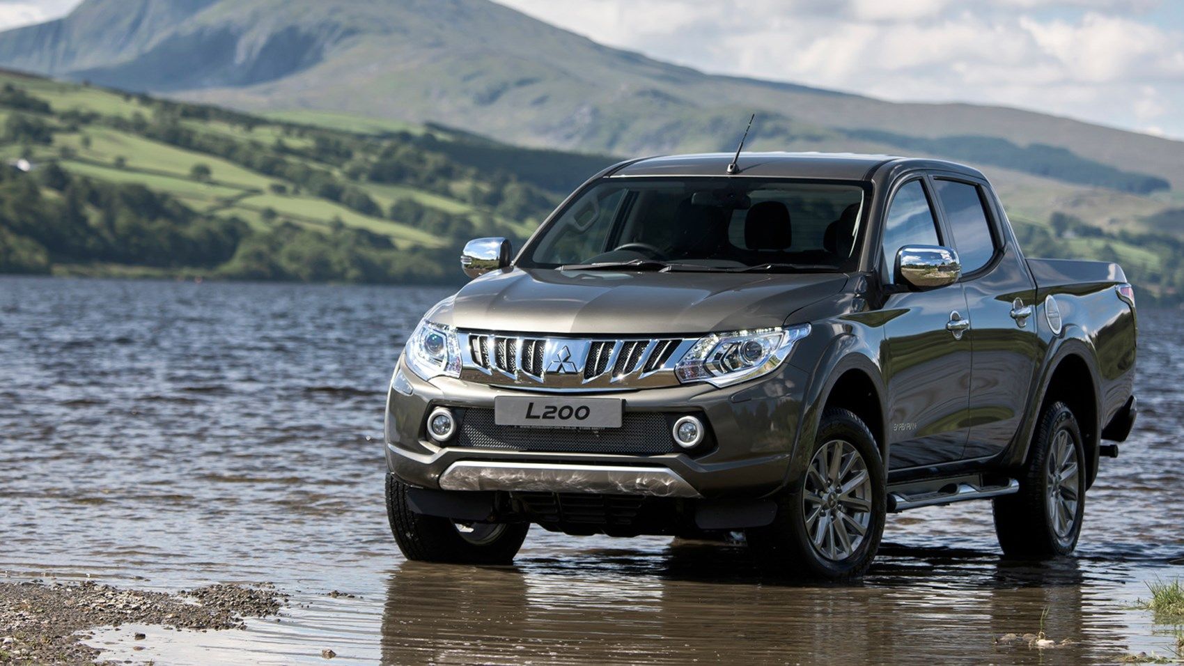 2016 Mitsubishi L200 - Trinton- Series-5 pickup parked in shallow water with mountains in background