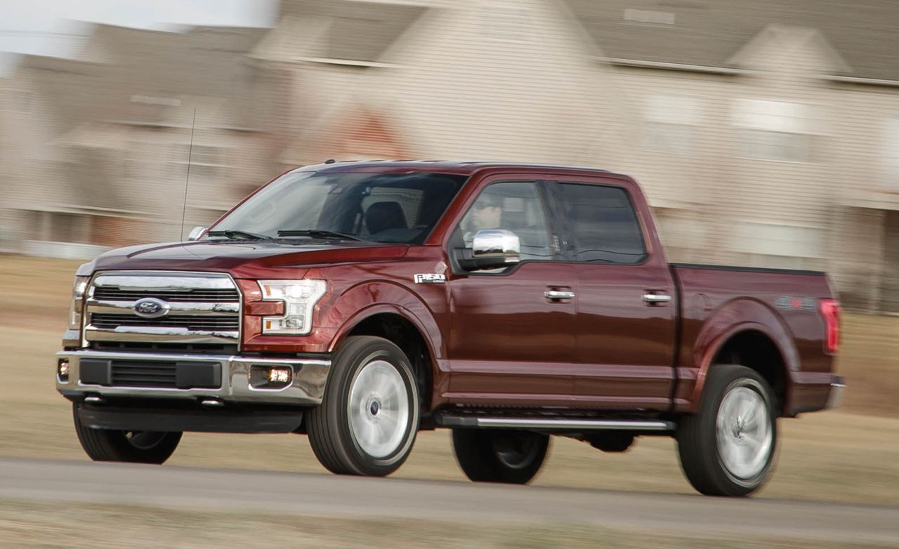 2016 Ford F-150 in motion on road, driving past houses