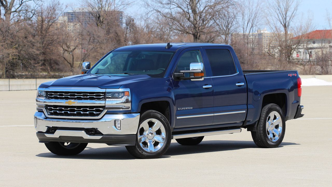 2017 Chevy Silverado 1500 parked in parking lot with trees in background, fall season