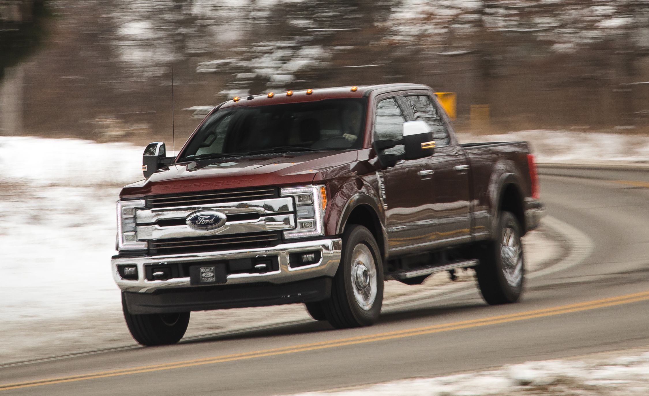2017 Ford F-350 in motion on a curved road with a snowy background
