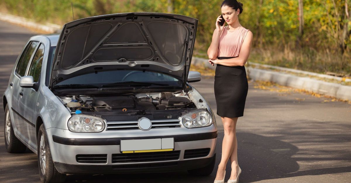 Broken down VW Golf and woman
