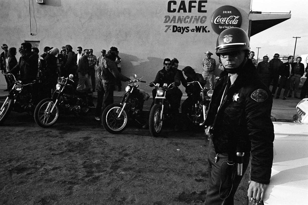 Police officer standing with Hell's Angels