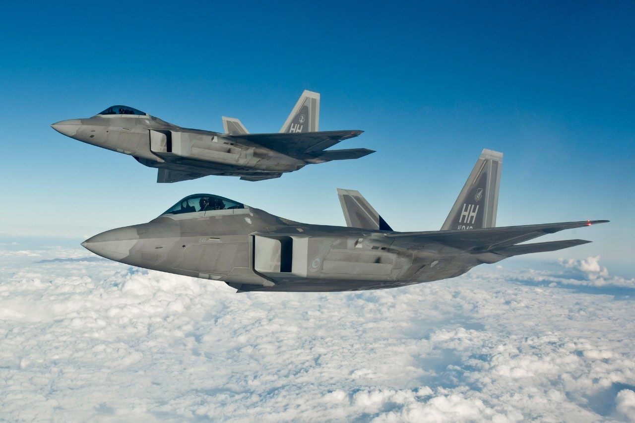 A pair of Lockheed Martin F-22A Raptors take to the sky