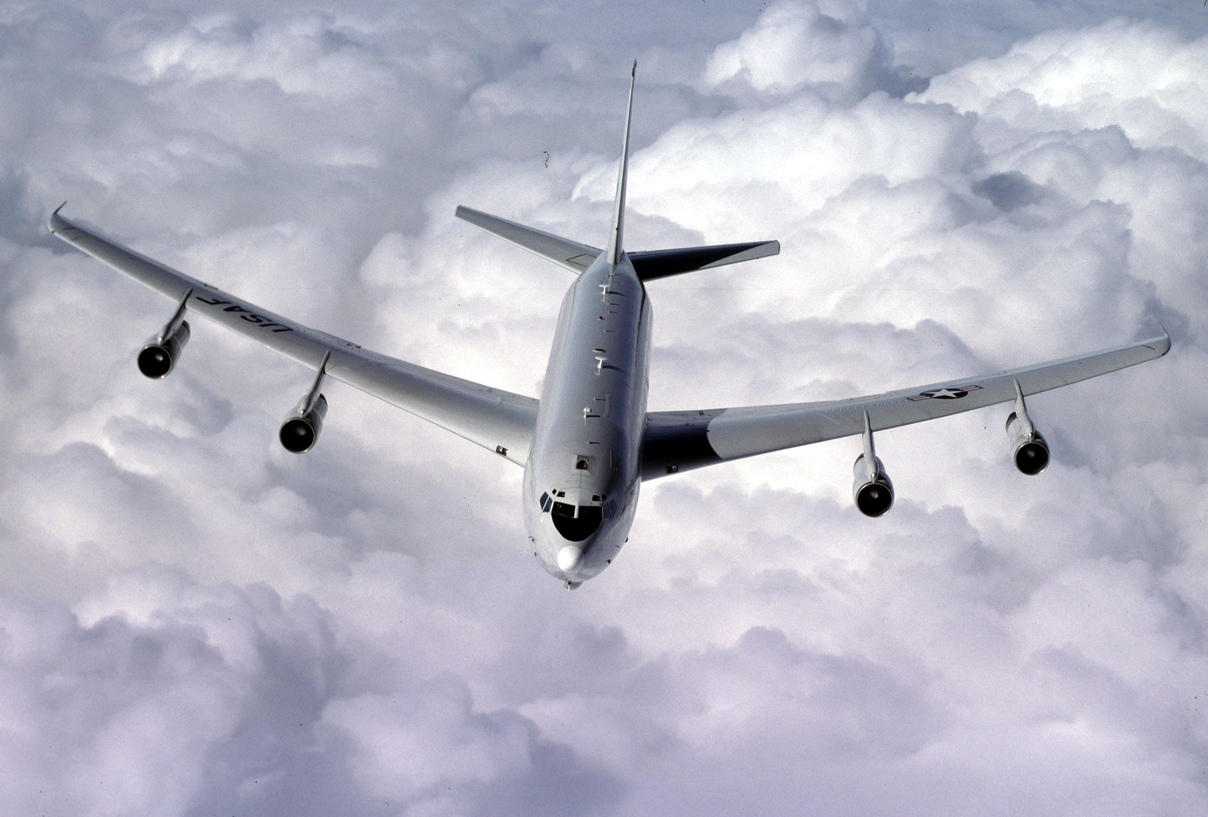 A E-8C Joint STARS buzzes a cloud bank