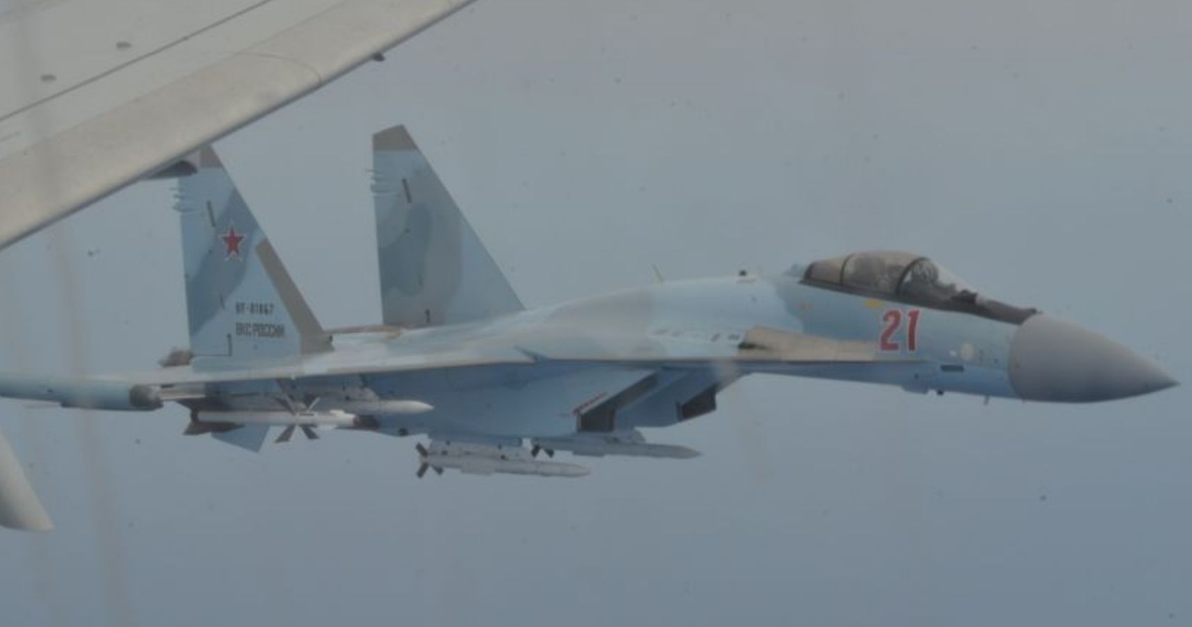 Russian Su-35 fighter flanks a Navy patrol plane