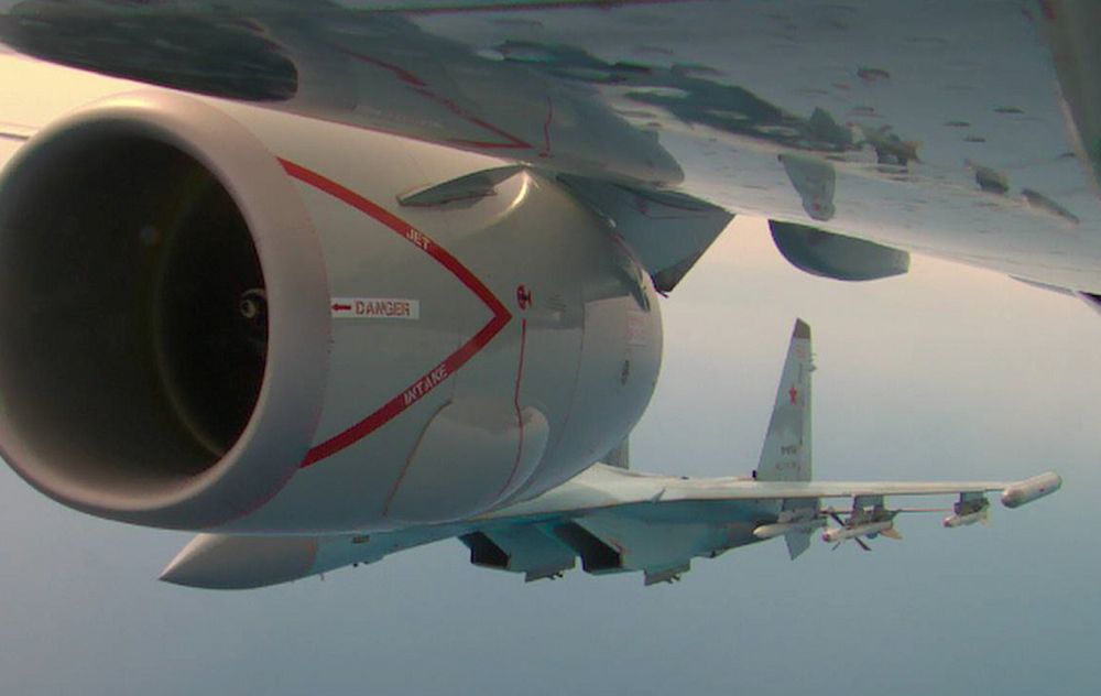 Russian Su-35 plane seen behind right engine of Navy aircraft