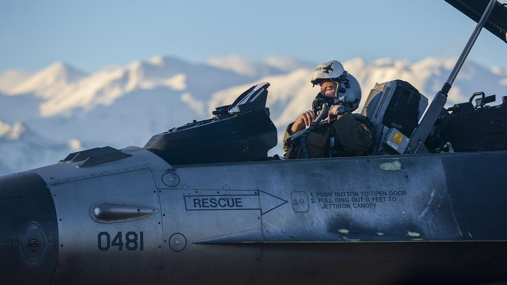A fighter pilot checks his face gear