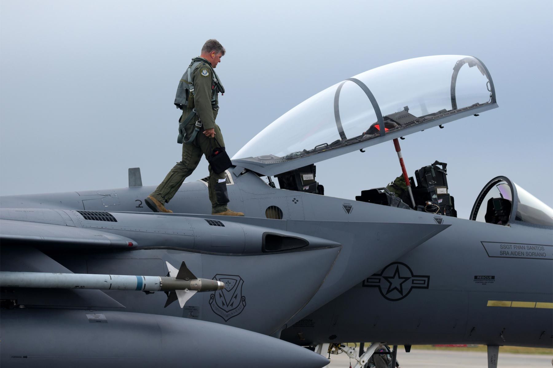 A pilot inspects an F-15E