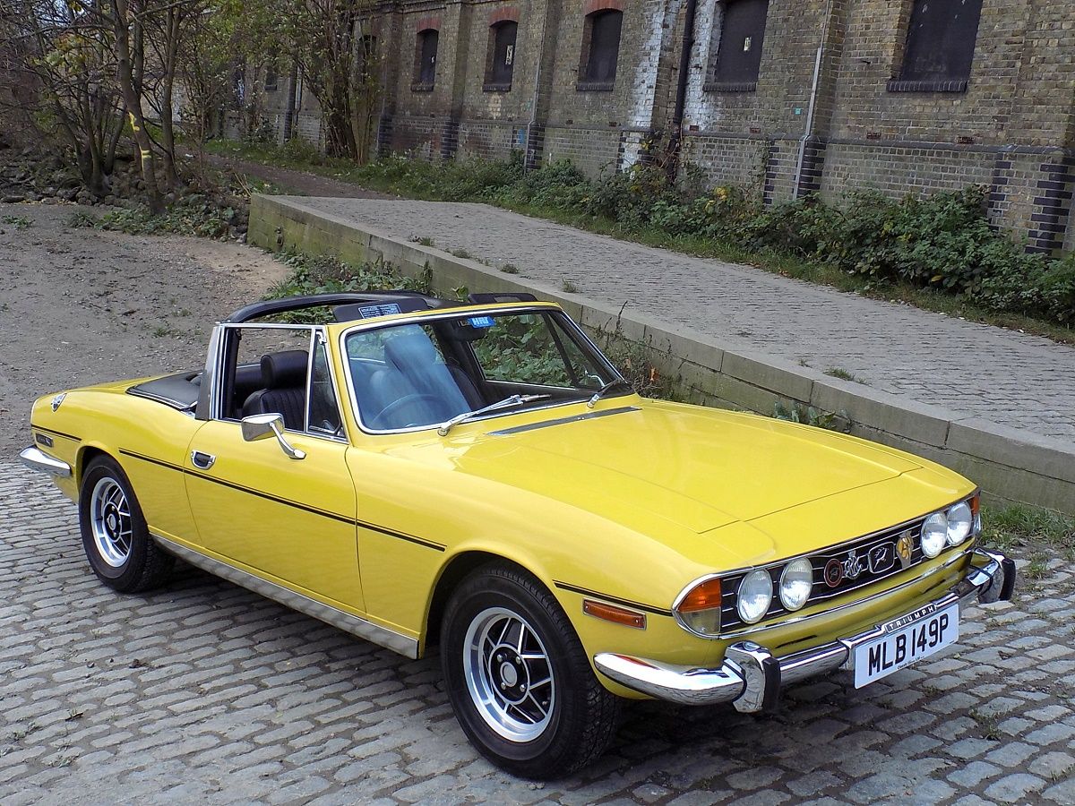 Inca Yellow 1975 Triumph Stag Mk2 parked on the pavement