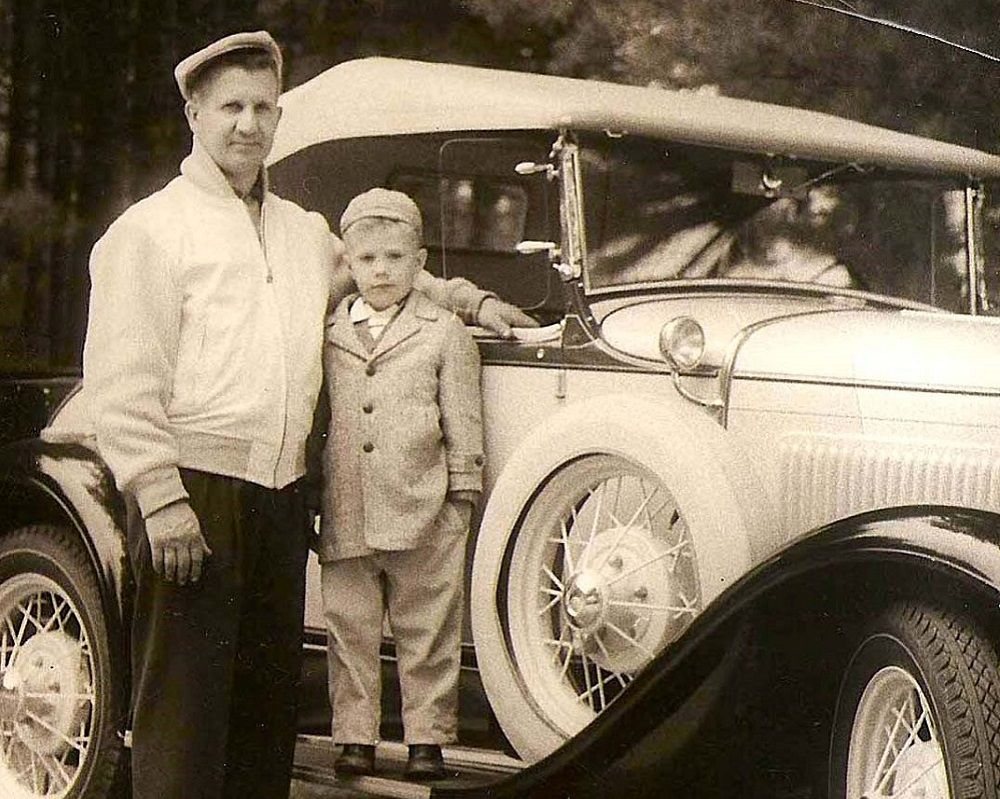 A Man And A Boy Standing Beside A Classic Car