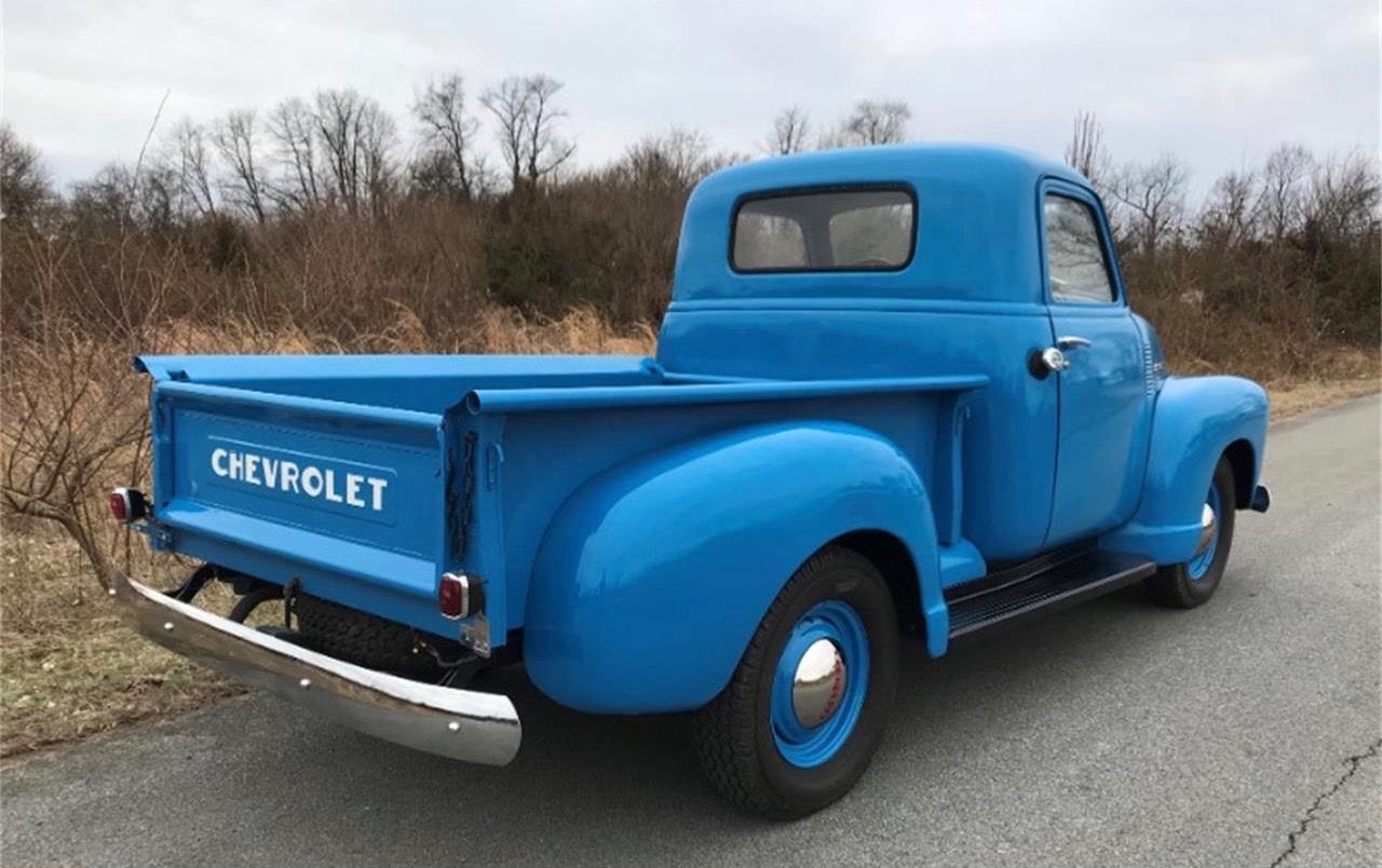 blue Chevrolet Advance Design series truck on the road