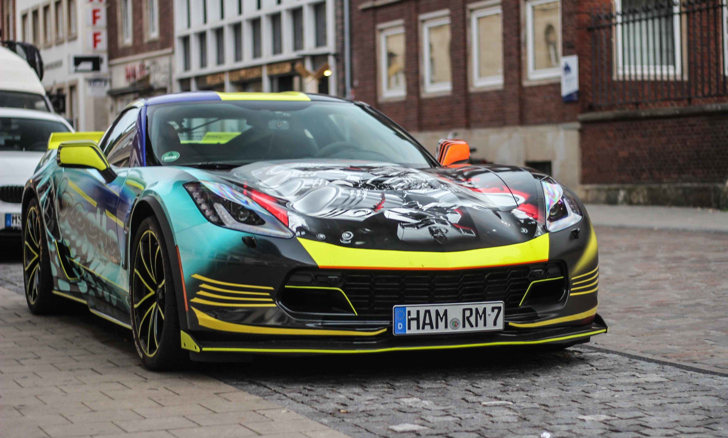There's a Chevrolet Corvette C7 Grand Sport underneath that technicolor throw-up