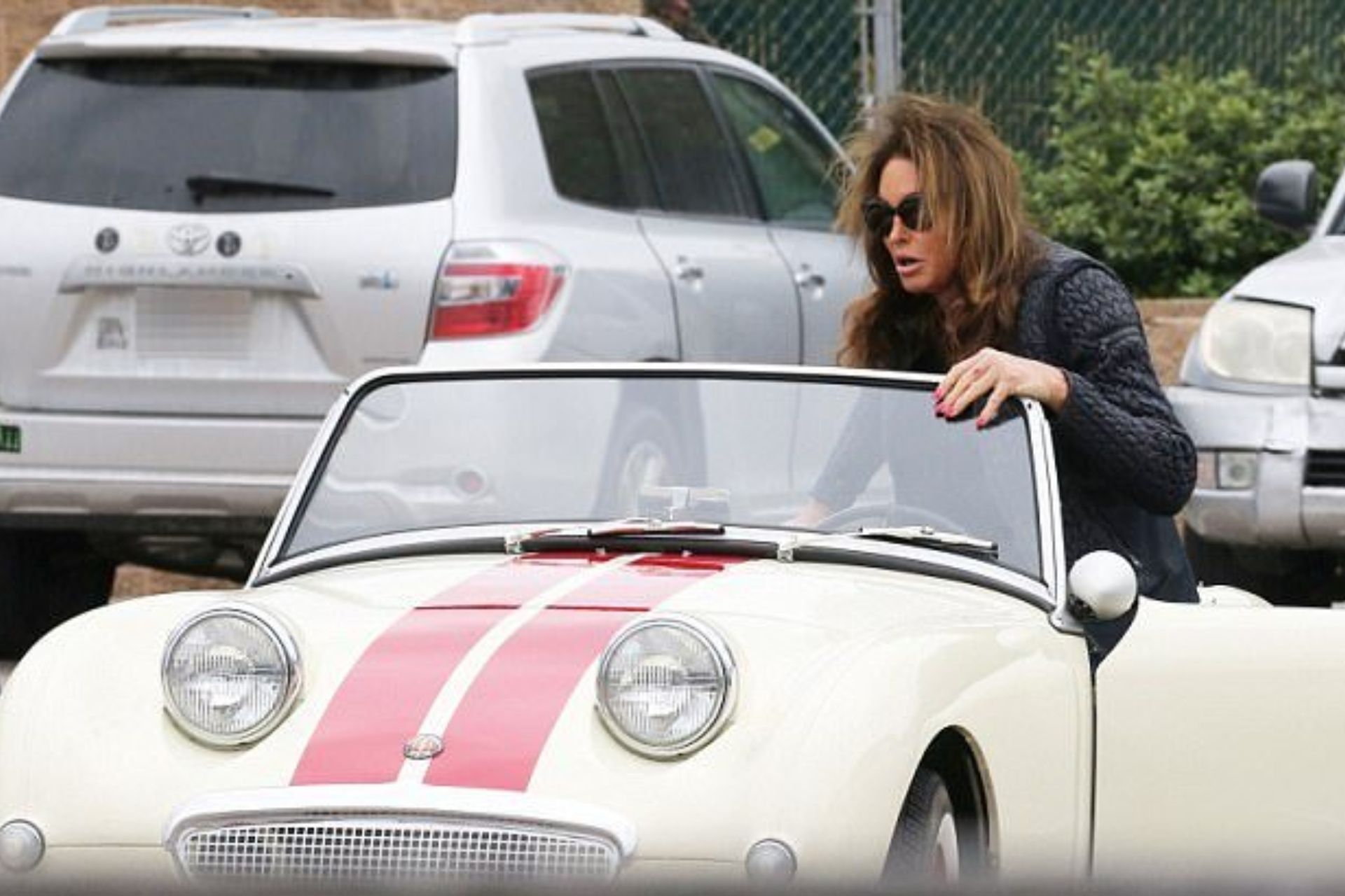 caitlyn jenner wears sunglasses while hopping in her car, ready to drive through malibu area