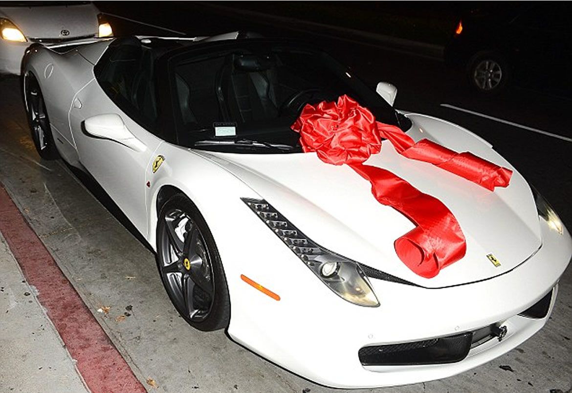 kylie jenner receives a white Ferrari 482 Italia with a red bow on it for her 18th birthday