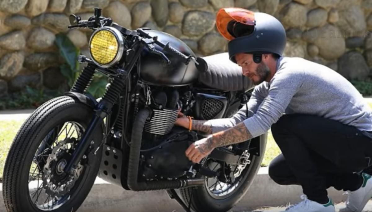 david beckham tinkering with a motorcycle