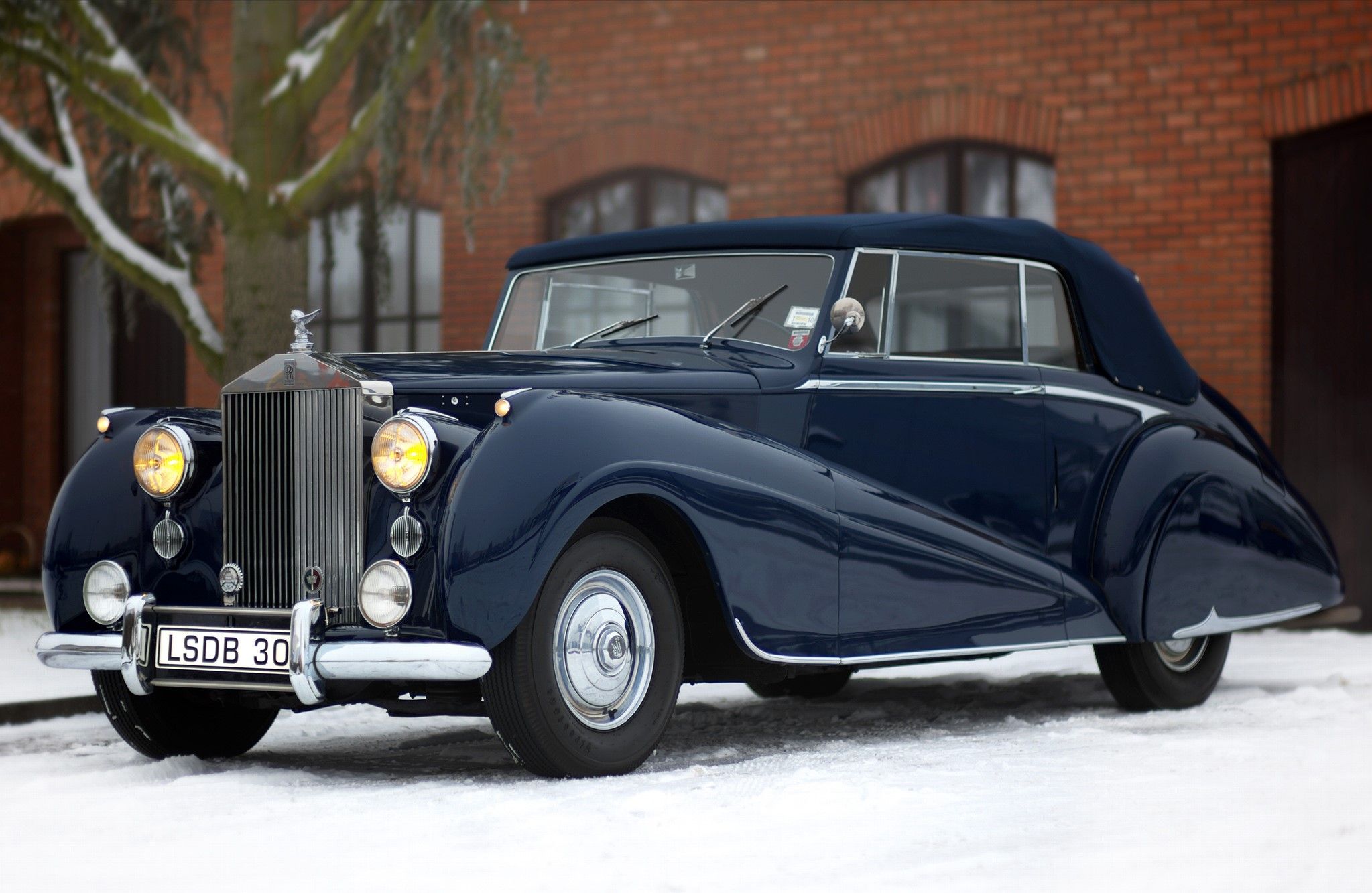 A black 1949 Rolls-Royce Dawn Drophead parked outside - on ice
