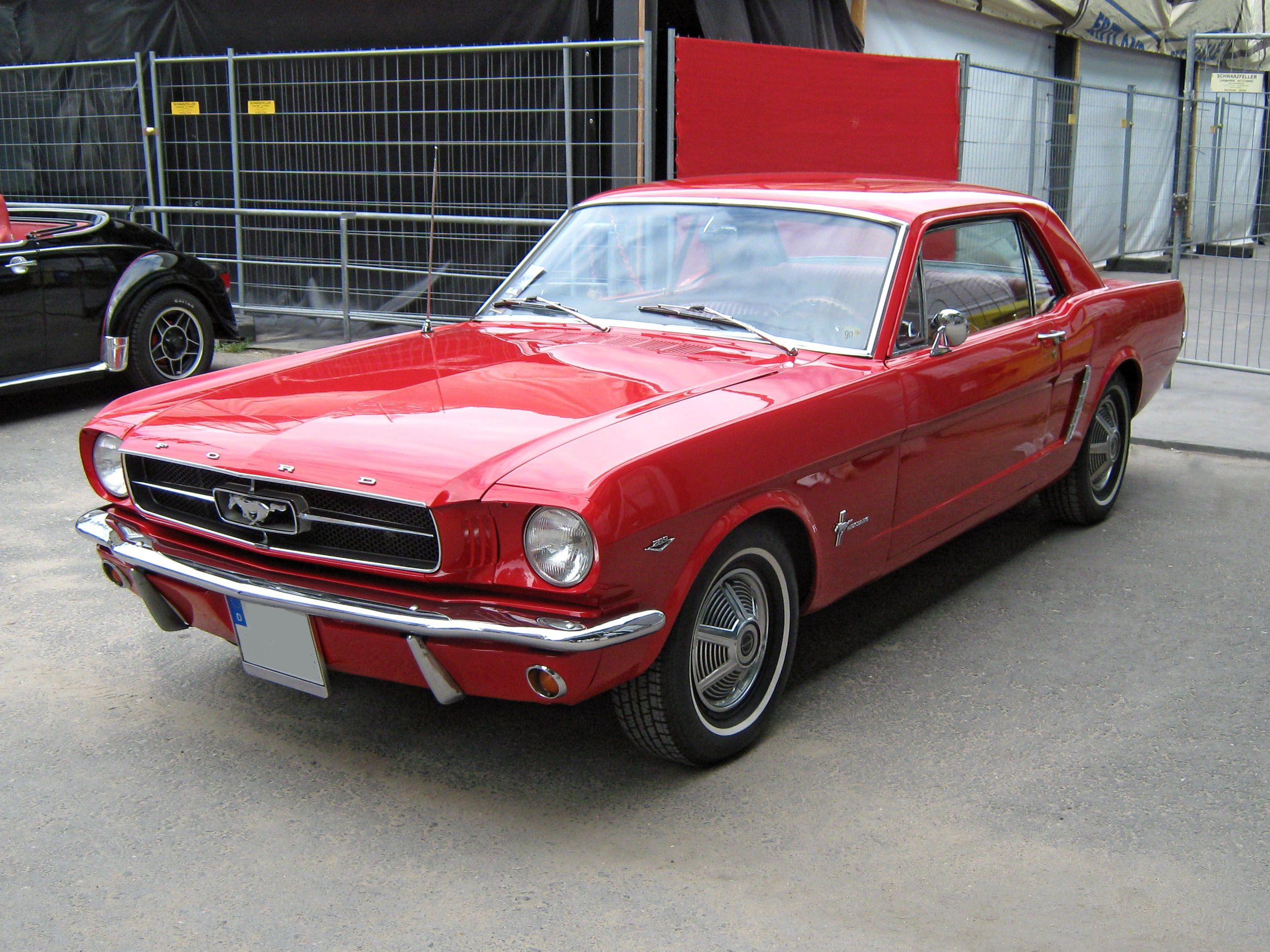 red Mustang with trunk open