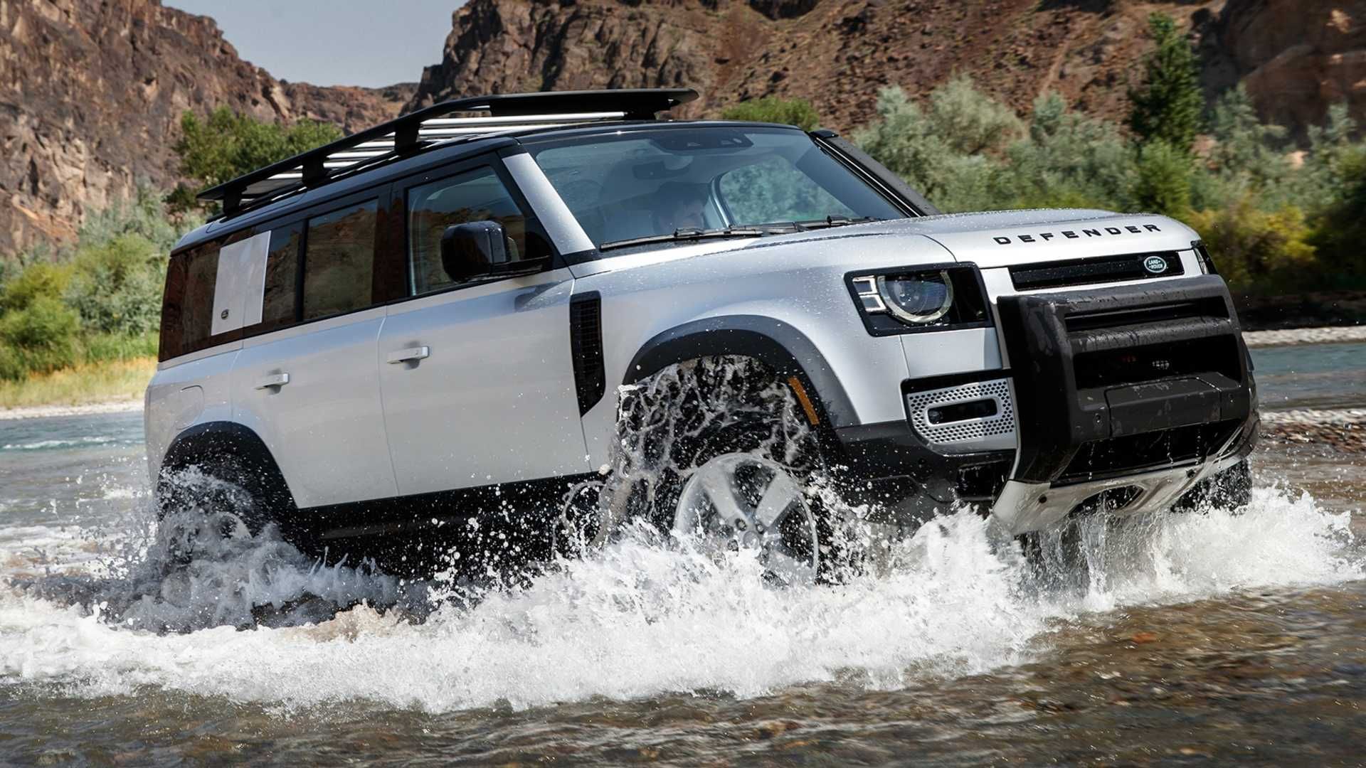 Fuji White 2020 Land Rover Defender driving across a river
