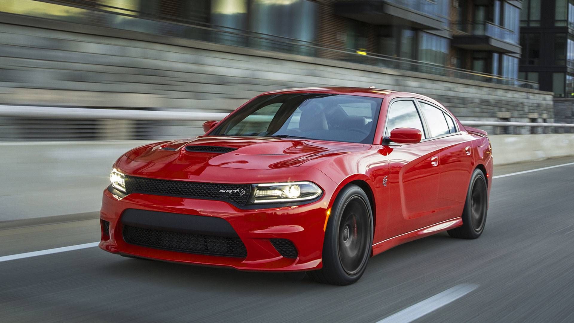 red Dodge Charger SRT Hellcat speeding on the highway