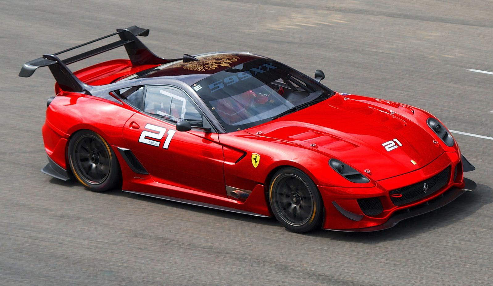 Red Ferrari 599XX Evoluzione speeding on a race track